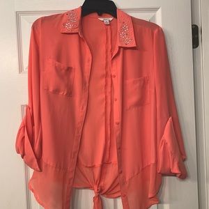 Peach colored button up blouse with tie